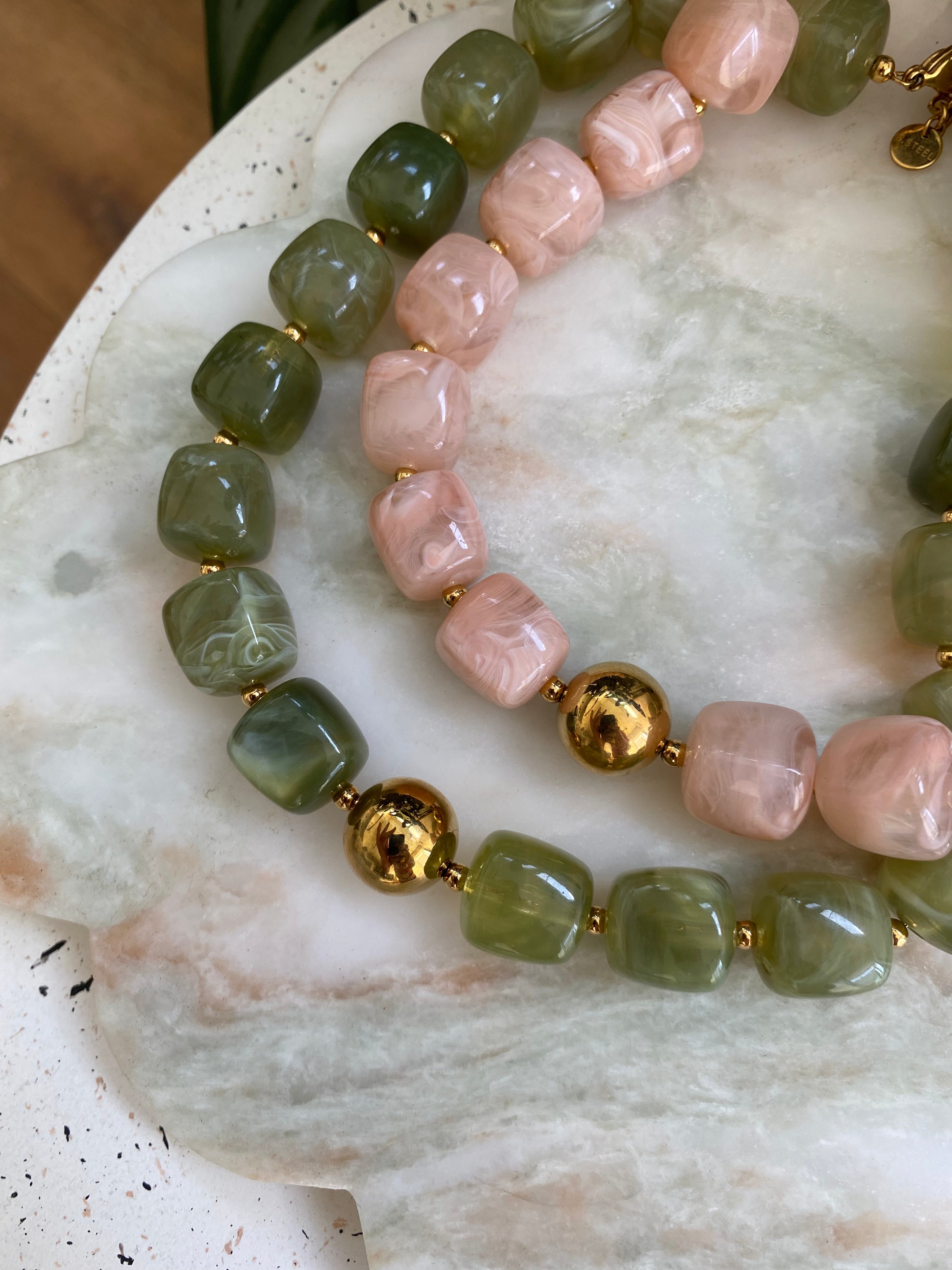 glass bead necklaces in a soft pink and light green colour
